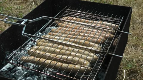 Grilling sausages on a bbq 스톡 동영상 7740703