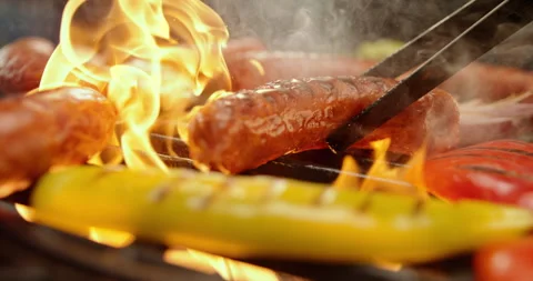 Grilling sausages on a charcoal grill Stock Footage 311831237