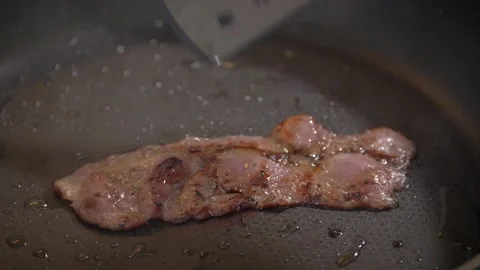 Grilling a slice of bacon Stock Footage 154334401
