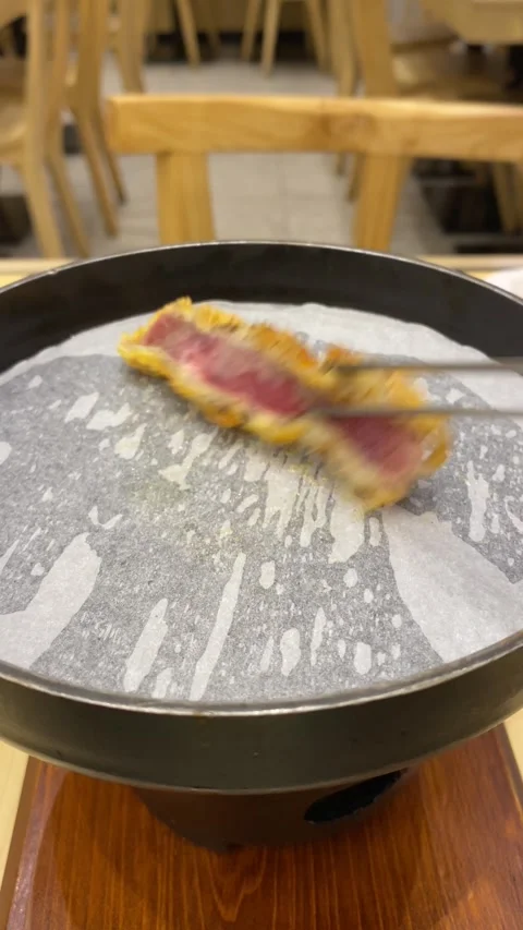 Grilling a slice of cheese beef katsu on small stove Stock Footage 295492180