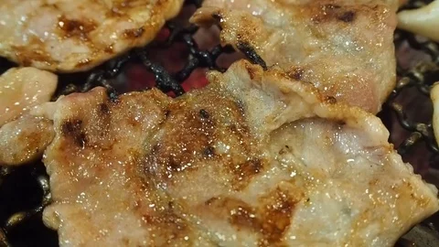 Grilling sliced pork on the grill. Stock Footage 84815632