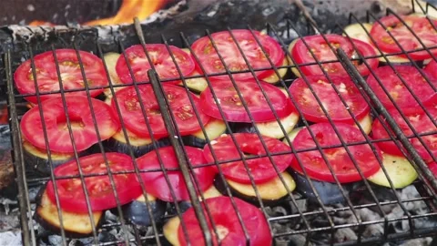 Grilling sliced tomatoes on fire barbecue close up Stock Footage 154347765