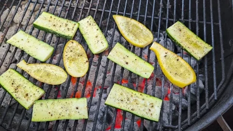 Grilling squash on a bbq looking down Stock Footage 296611977