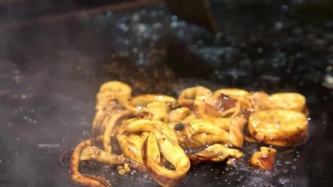 Grilling squid on a hot grill. while stirring, stir until cooked Stock Footage 268515842