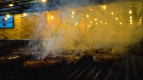 Grilling steak on barbecue, close up Stock Footage 107163690