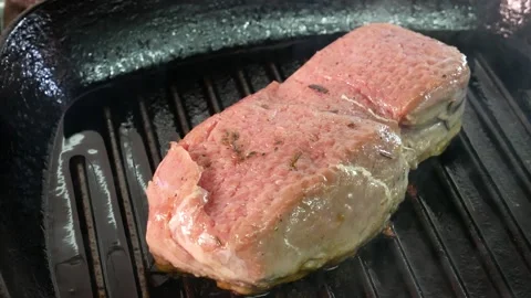 Grilling steak on a grill pan. Beef tender steak on the grill pan. Stock Footage 131320121