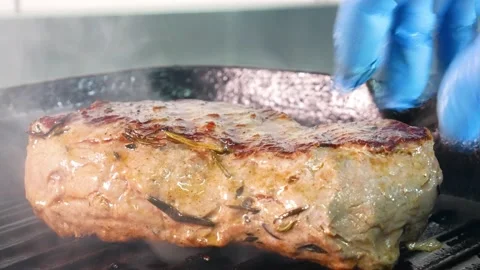 Grilling steak on a grill pan. Beef tender steak on the grill pan. Видео 131320830