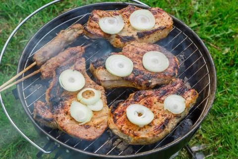 Grilling steaks at summer weekend Stock Photos