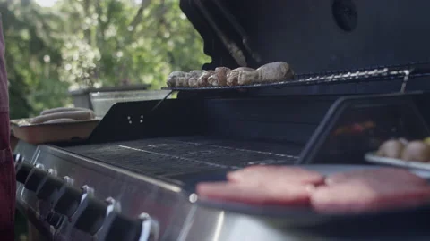 Grillmaster dad adds more chicken to the grill Stock-Footage 153311074