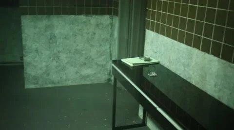 Grim interrogation room with bench through window. Stock Footage 64474930