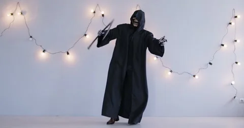 Grim Reaper Dancing with Scythe at Halloween Party Stock Footage 287896826