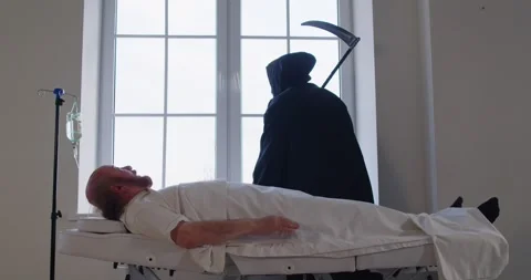 Grim Reaper of Death with scythe finding victim in hospital, clinic ward Stock Footage 310165395