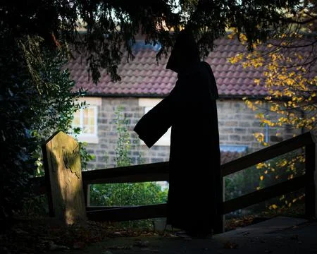The grim reaper standing on a grave 스톡 사진
