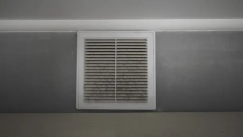 Grimy ventilation duct cover on a wall full of dust, dirt, and mold. Urgent Stock Footage 345671160