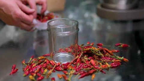 Grind in an automatic blender grind red chili pepper woman hand's added Stock Footage 301287613