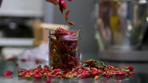 Grind in an automatic blender grind red chili pepper woman hand's added Stock Footage 301289196