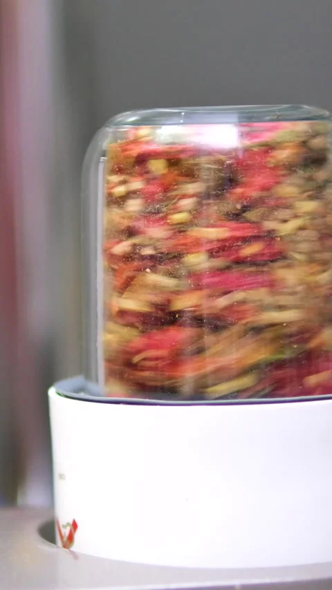 Grind in an automatic blender grind red chili pepper woman hand's added Stock Footage 302078588