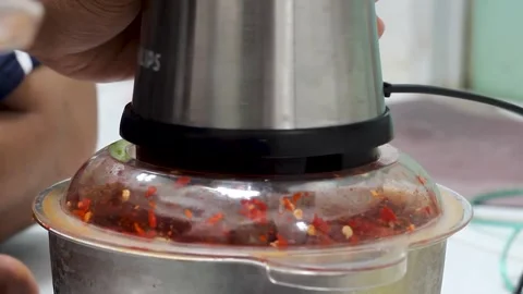 Grind the chillies using a blender machine. Stock Footage 276152137
