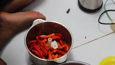 Grind the chillies using a blender machine. Stock Footage 276152615