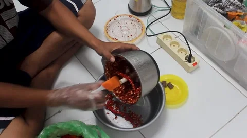 Grind the chillies using a blender machine. Stock Footage 276152691