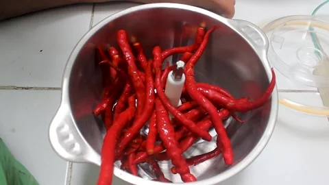 Grind the chillies using a blender machine. Stock Footage 276152793