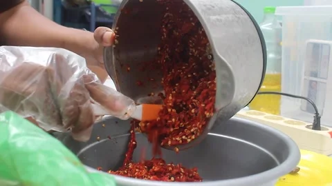 Grind the chillies using a blender machine. Stock Footage 276152799
