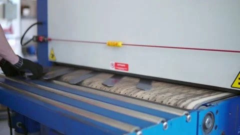 Grind a CNC car. A production worker takes the finished parts of the convergence Stock Footage 201820617