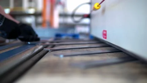 Grind a CNC car. A production worker takes the finished parts of the convergence Stock Footage 201821914