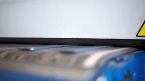 Grind a CNC car. A production worker takes the finished parts of the convergence Stock Footage 201822069