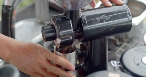 Grind coffee beans.The black coffee grinder grinds fine grains.Coffee shop. Stock Footage 243960324