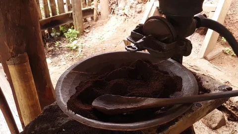 Grind coffee using an old traditional coffee grinder from Thai hill tribe people Stock Footage 82466296