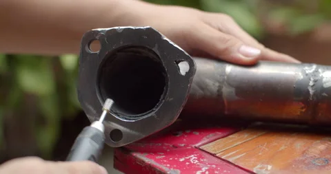 Grind the edges of the pipe after welding to make the exhaust flow more easily. Stock Footage 313496241