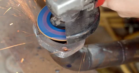 Grind the edges of the pipe flange after welding. Stock Footage 313496137