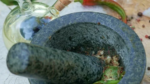 Grind the spices with a stone mortar. Stock Footage 146790207