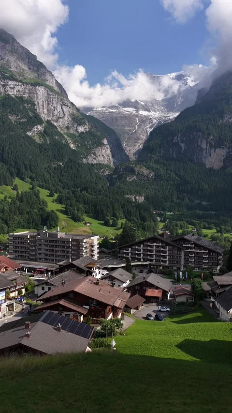 Grindelwald village resting below the eiger mountain in the swiss alps Stock Footage 318592751