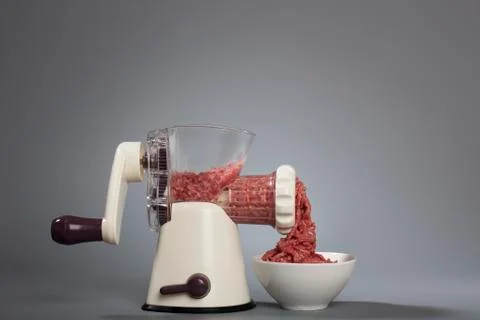 Grinder processing minced meat Stock Photos