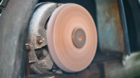 Grinder. Rotating disk of grinding machine. A machine for turning a round shape. Stock Footage 112684579