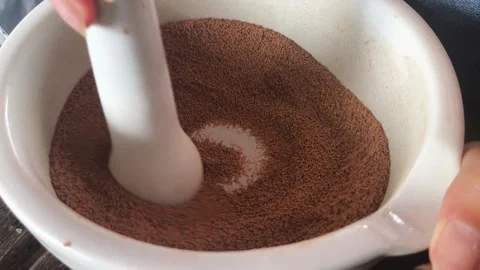 Grinding aquaculture feed pellets using porcelain mortar and pestle close up Stock-Footage 344878964