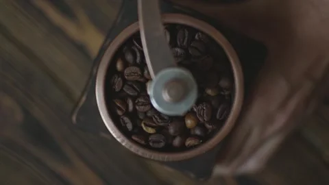 Grinding of aromatic coffee beans with a manual coffee grinder Video stock 291604860