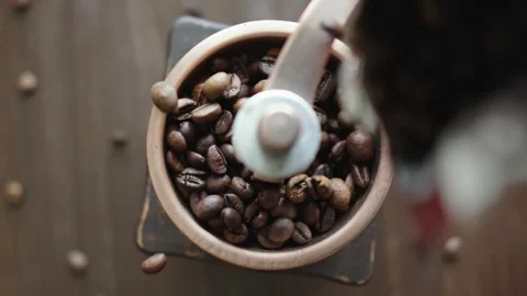 Grinding of aromatic coffee beans with a manual coffee grinder Stock Footage 312134067