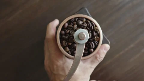 Grinding of aromatic coffee beans with a manual coffee grinder Stock Footage 312134069