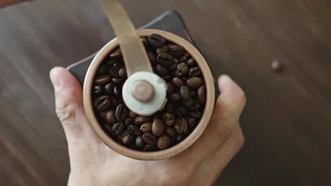 Grinding of aromatic coffee beans with a manual coffee grinder Stock Footage 312134167