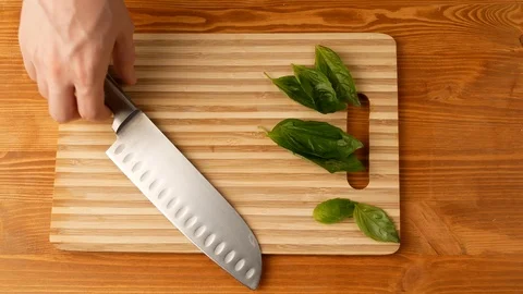Grinding the basil with a knife, the top view. Stock Footage 108274693