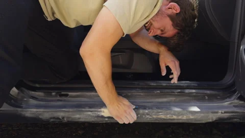Grinding a car part. Close-up: A man sands car parts for painting. Body work Stock Footage 278035650