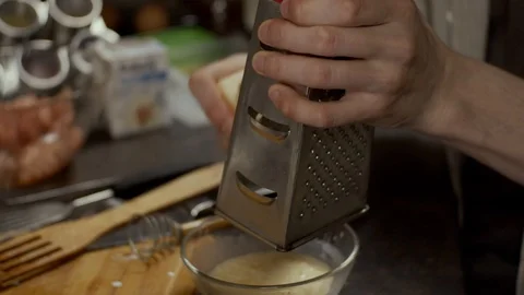 Grinding cheese with grater Stock Footage 126470921