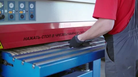 Grinding a CNC machine. The production worker gives parts to the converge of the Stock Footage 201821534