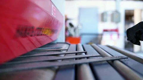 Grinding a CNC machine. The production worker gives parts to the converge of the Video stock 201821791