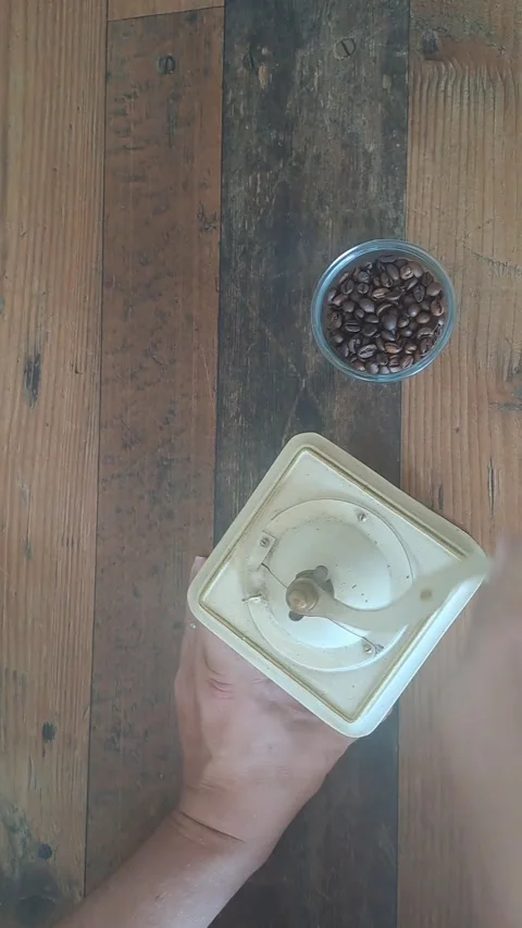 Grinding coffee beans with a manual coffee grinder. Stock Footage 342071229