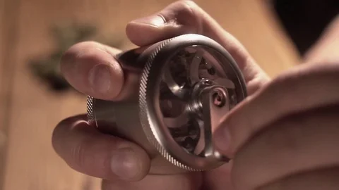Grinding cones of marijuana with a grinder close-up. Weed buds and grinder in 스톡 동영상 83050603