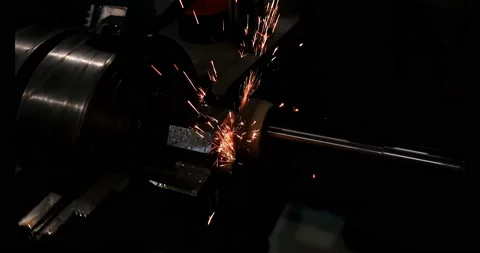 Grinding the end face of the part with an abrasive stone with sparks Stock Footage 153425589